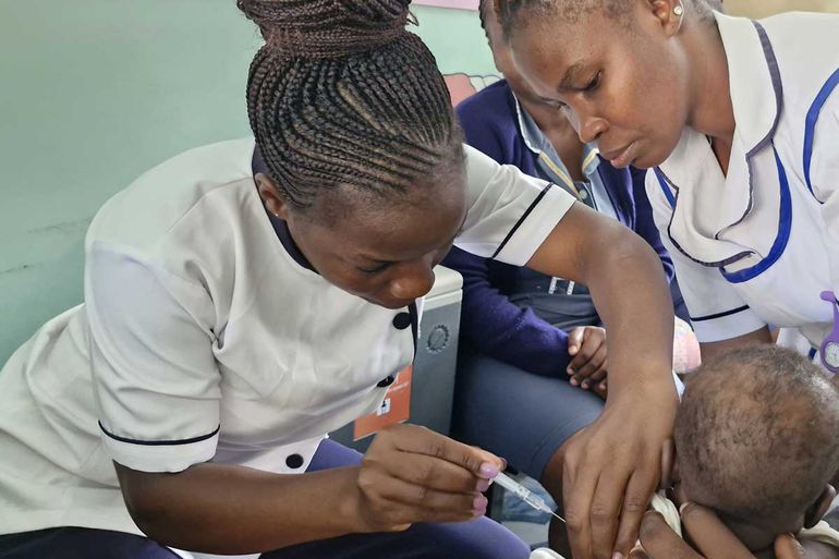 Nurses administering a vaccine