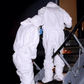 Health professionals wearing protective gear while transporting an Ebola patient. (Image: WHO)