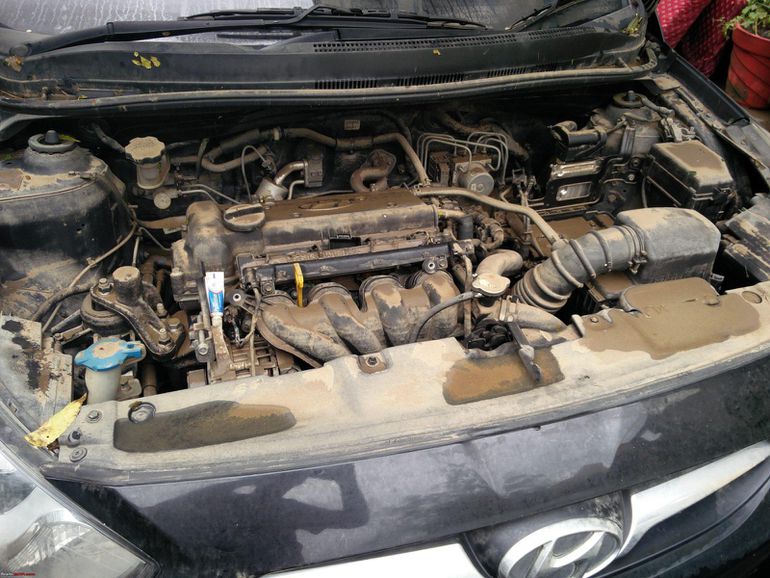 A vehicle with the bonnet popped open to display the engine