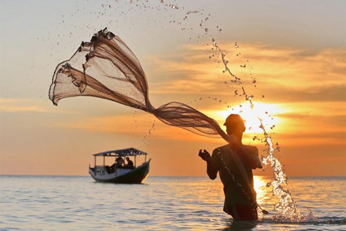 A fisherman casting his net