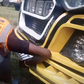 An inspection officer removing the number plates from Money Fest matatu