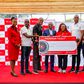 Kenya Airways, Chief Commercial and Customer Officer, Julius Thairu hands over the partnership cheque to the KOGL board members