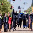 Graduates throwing their hats in the air to celebrate