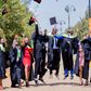 Graduates throwing their hats in the air to celebrate