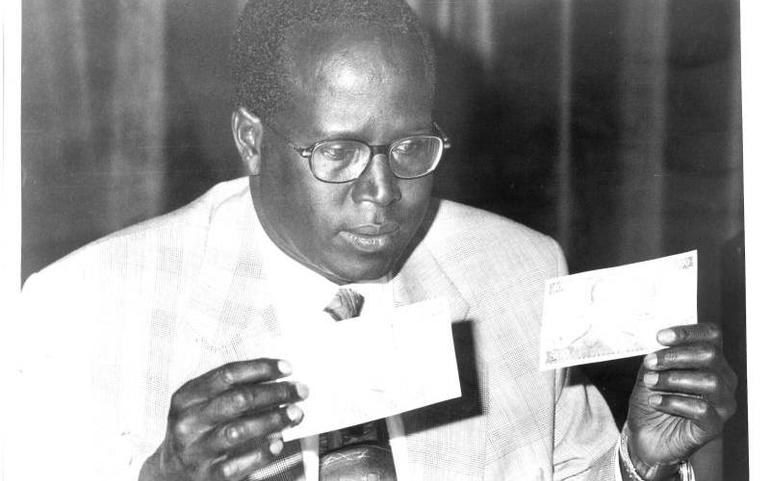 Micah Cheresem, during his time as CBK Governor, holding Sh500 notes - Photo/Courtesy