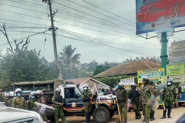 Police armed with clubs, some in anti-riot gear at Boniface Kariuki's burial