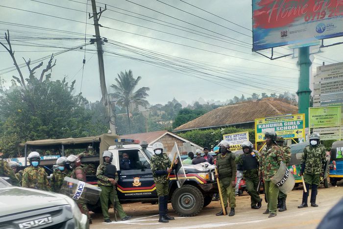 Police armed with clubs, some in anti-riot gear at Boniface Kariuki's burial