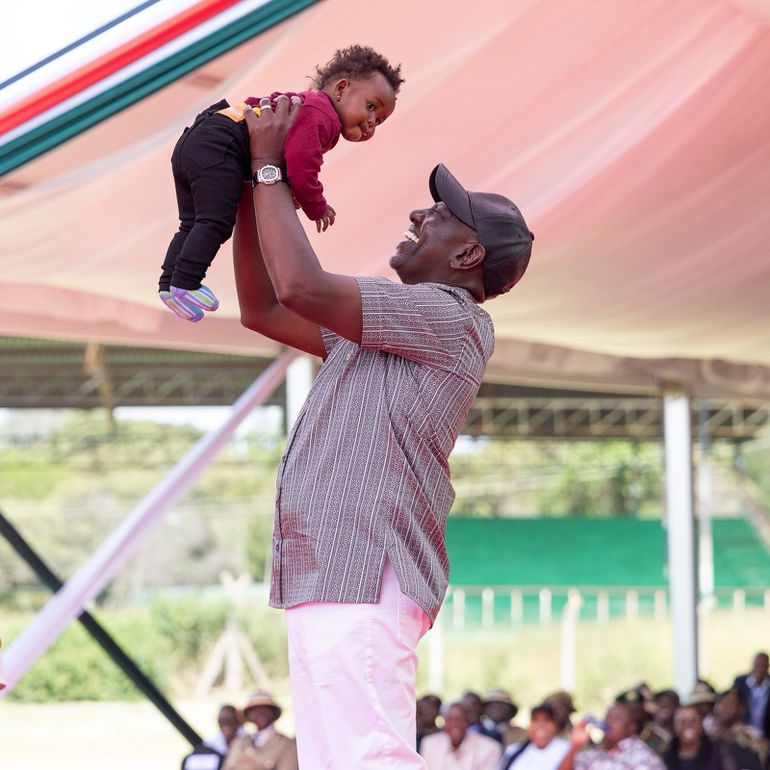 President William Ruto with Gathoni's child during the NYOTA event at the Kabiru-ini ASK Grounds