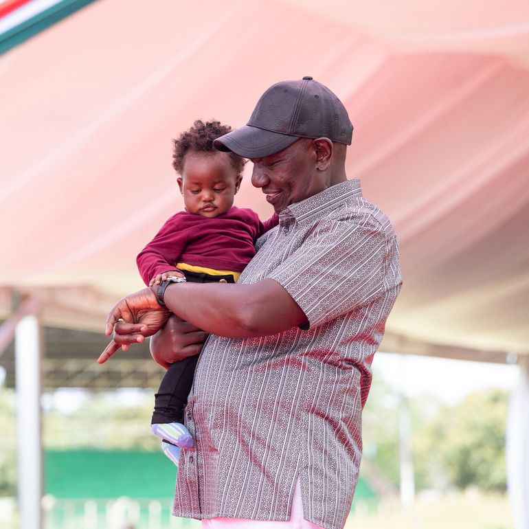 President William Ruto with Gathoni's child during the NYOTA event at the Kabiru-ini ASK Grounds