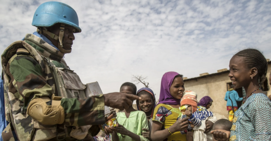 File image of a UN Peace-keeping mission soldier with local children in Africa