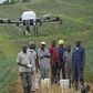 Farmers using a drone in the field