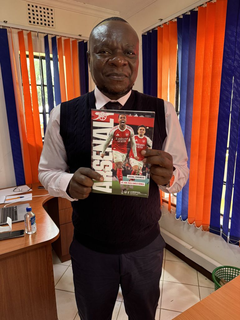 ODM Director of Communications Philip Etale, who received the package, displays the commemorative booklet