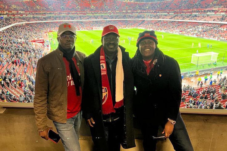 Former Prime Minister of the Republic of Kenya, The Late Raila Amolo Odinga (middle), poses with his children Raila Jr. (left) and Winnie Odinga (right) at the Emirates Stadium at a past Arsenal match