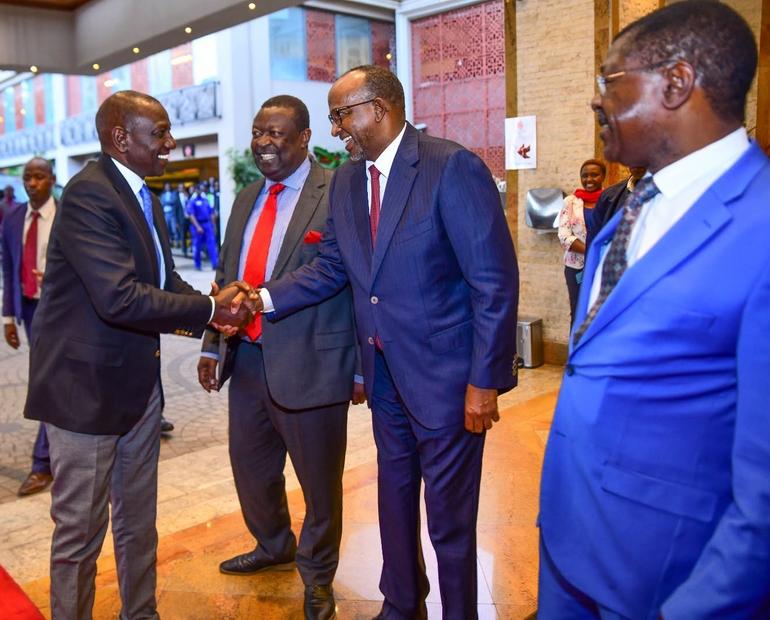 Health Cabinet Secretary Aden Duale shaking hands with President William Ruto.