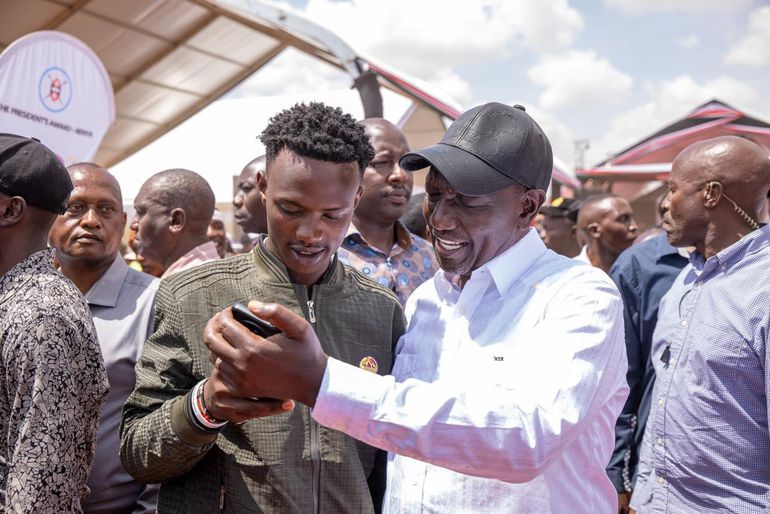 President William Ruto interacting with a NYOTA program beneficiary