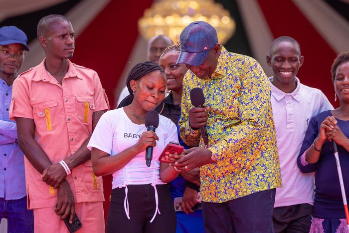 President William Ruto interacting with a NYOTA program beneficiary