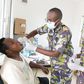 A Kenya Defence Forces specialist officer (middle) offers dental services to a civilian