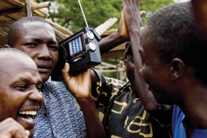 People listening to a radio
