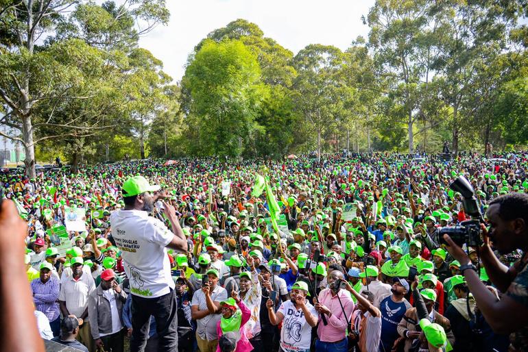A crowd heavily donned in DCP colors listen to their candidate Sammy Kamau Ngotho ahead of the by-elections in Ol Kalou (Image: Files)