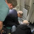 Russian Health Minister Mikhail Murashko attending to a passenger's emergency