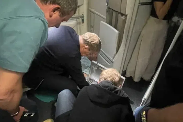Russian Health Minister Mikhail Murashko attending to a passenger's emergency