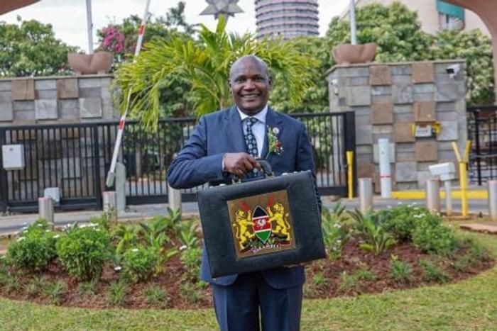 National Treasury Cabinet Secretary John Mbadi lifts the budget briefcase at the National Treasury ahead of the Budget 2026/27 statement in Parliament.