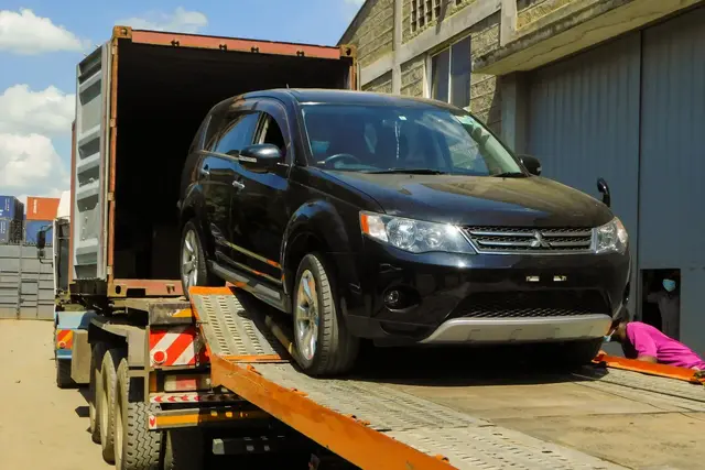 A vehicle being offloaded from a truck