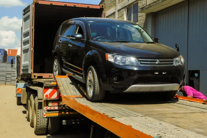 A vehicle being offloaded from a truck