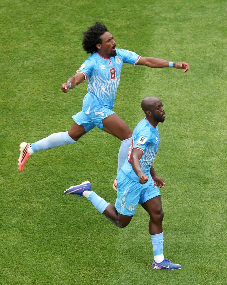 Congolese players celebrate after scoring a goal in their match against Portugal