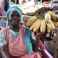 Jennifer Nagut from Maero village in Uganda displays the bananas at her stall in Busia, Kenya. She is among several Ugandan women who cross the border every day to sell nutritious foodstuffs to Kenya | Photo by Faith Matete