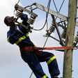 Kenya Power staff fixing a transmission line