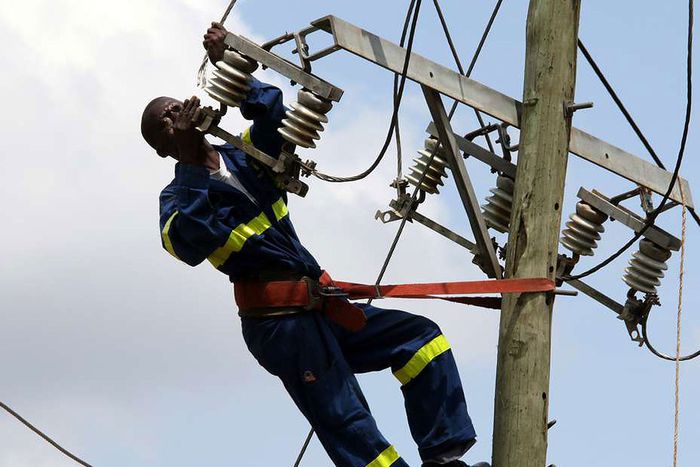 Kenya Power staff fixing a transmission line