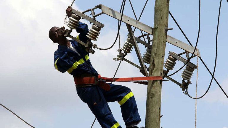 Kenya Power staff fixing a transmission line