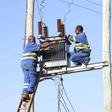 Kenya Power staff fixing a transformer