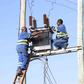 Kenya Power staff fixing a transformer