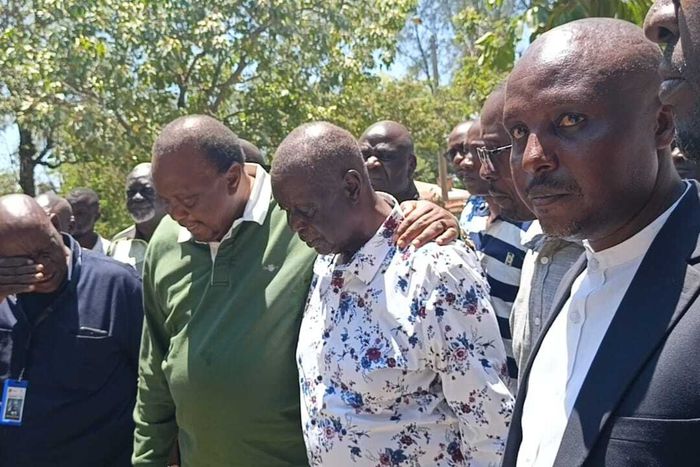 Former President Uhuru Kenyatta and Oburu Odinga at the grave of Raila Odinga in Bondo