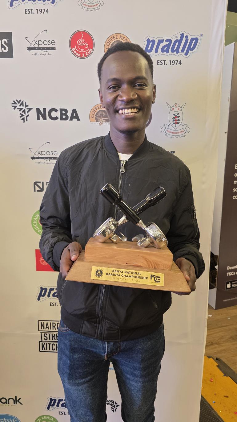 Champion Barista Kennedy Owino displays the the 22nd Kenya National Barista Championship trophy at Nairobi Street Kitchen (Image: Files)
