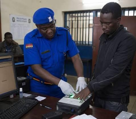 An undated image of a Kenyan police officer taking finger prints of a suspect after arrest (Image: Files)
