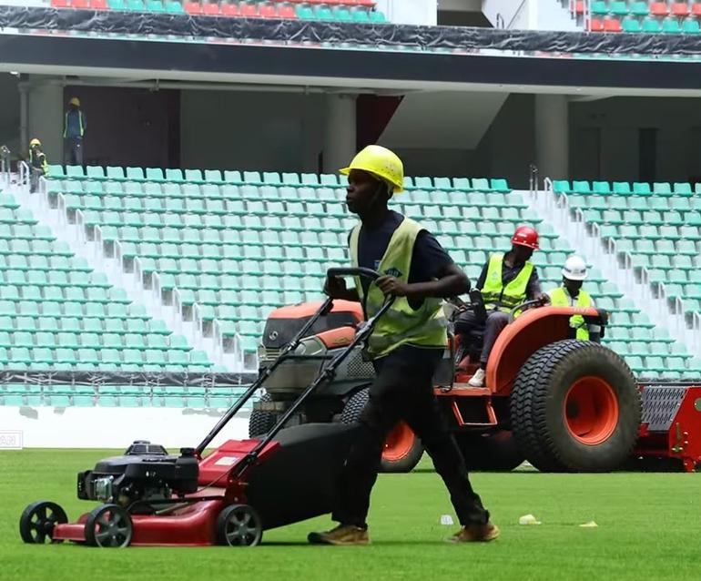 Stitching synthetic fibres into the grass at Talanta Sports City.