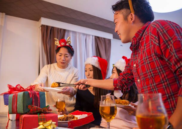 A young Japanese couple are enjoying Christmas at home.