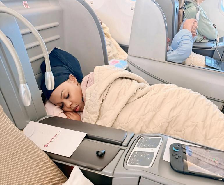 Businesswoman Muthoni aka Baby Top takes a nap in the business class section on a Kenya Airways flight from Nairobi to London (Image: Files)