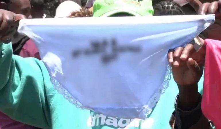 A screen grab image of a resident holding underwear that was among those given to residents in Kirinyaga