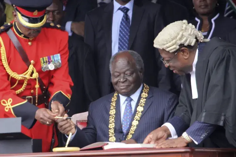 On August 27, 2010, Kibaki officially signed the supreme law into effect, raising the new constitution booklet aloft in front of an exuberant crowd (Image: Files)