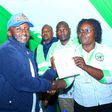 Kasipul MP-elect Boyd Were receives his certificate of victory from an IEBC official. Boyd Were is immediate former Kasipul MP Charles Ong'ondo Were's son.