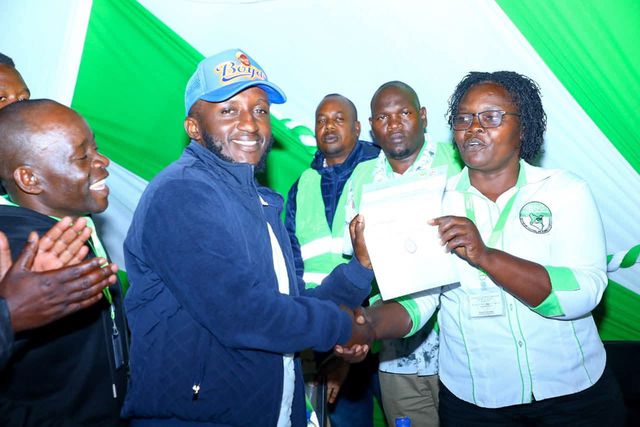 Kasipul MP-elect Boyd Were receives his certificate of victory from an IEBC official. Boyd Were is immediate former Kasipul MP Charles Ong'ondo Were's son.