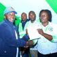 Kasipul MP-elect Boyd Were receives his certificate of victory from an IEBC official. Boyd Were is immediate former Kasipul MP Charles Ong'ondo Were's son.