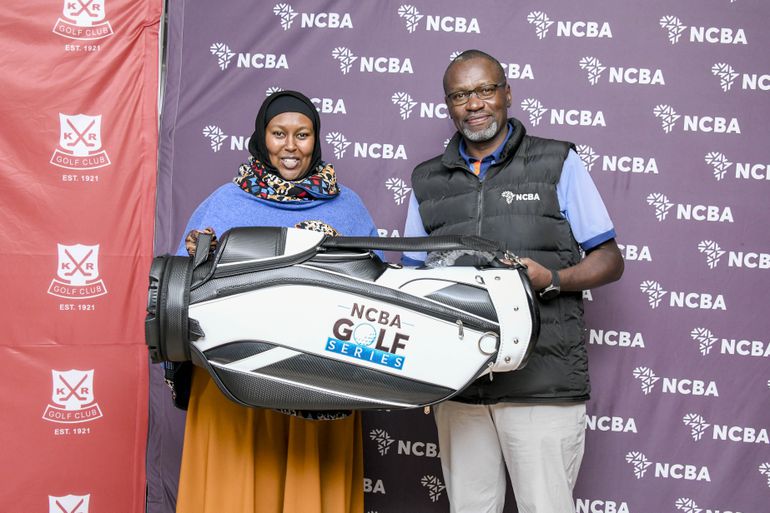 Aisha Duba, Division One Ladies category winner of the NCBA Golf Series at Railway Golf Club receives a golf bag prize from Charles Omondi, NCBA Director, Corporate Banking