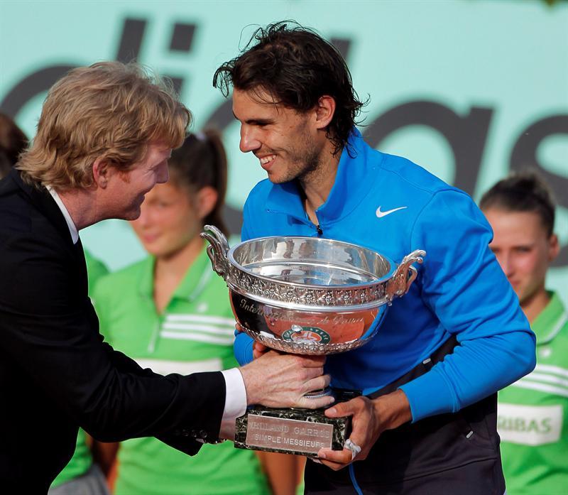 Nadal recibe el trofeo de manos del ex campeón, Jim Courier. FOTO: EFE