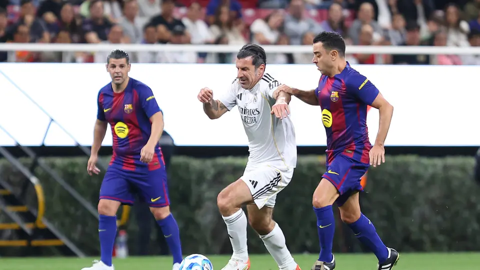 Xavi Hernández peleando el balón con Luis Figo en el Clásico de Leyendas | IMAGO7