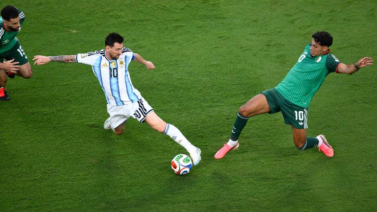 Dos jugadores argelinos tratando de robarle el balón a Messi | AP